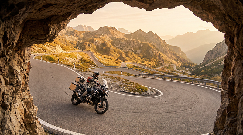 Guy working hard on road on motorcycle